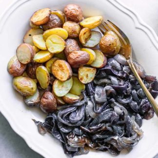 baked onions and potatoes side dish on a white table