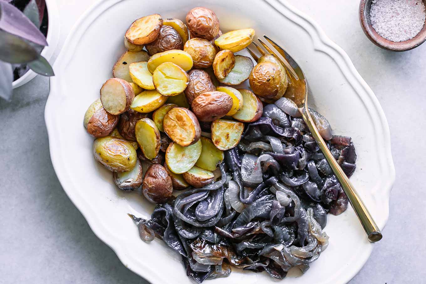 baked onions and potatoes side dish on a white table