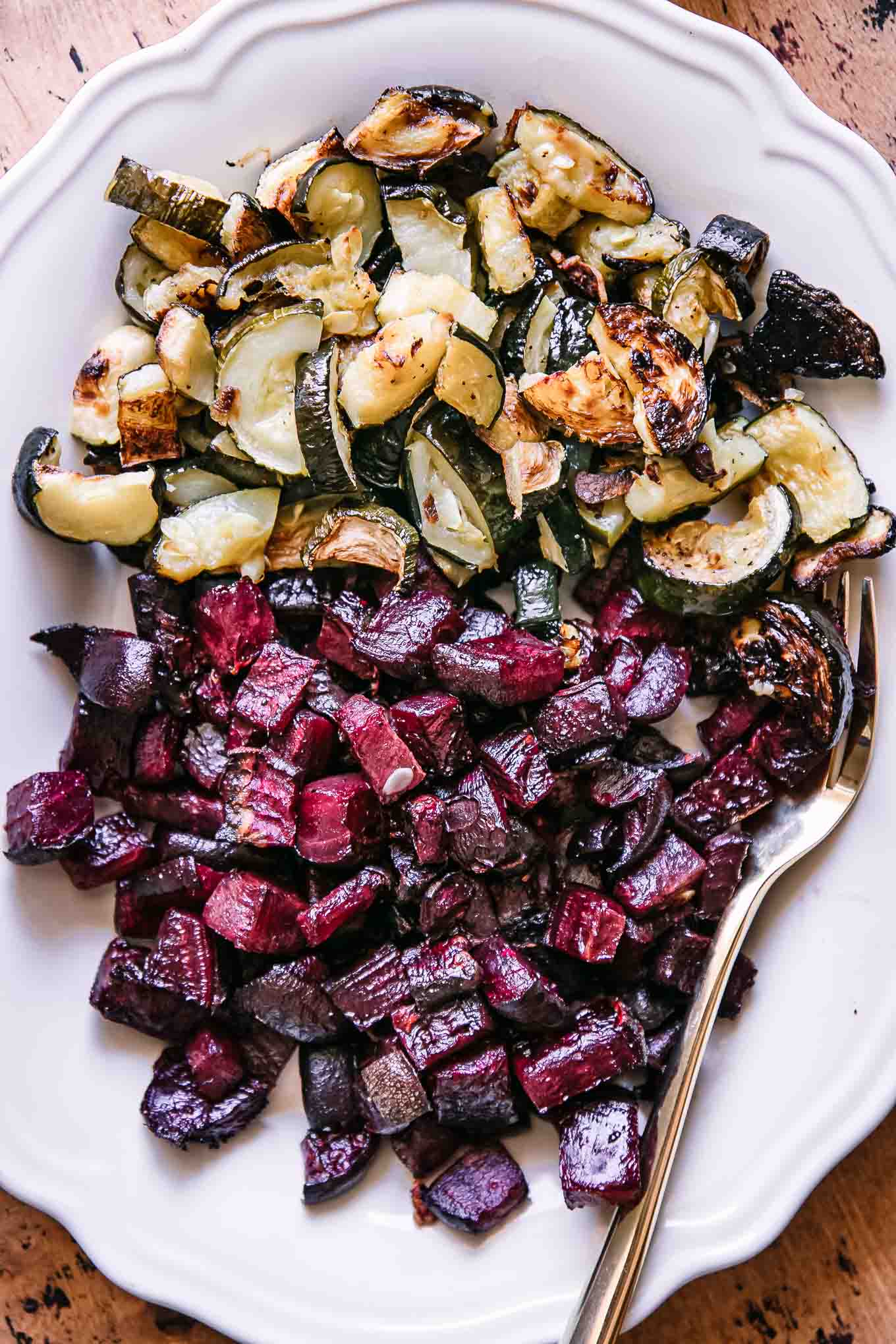 a close up of photos of roasted beets and zucchini on a white plate