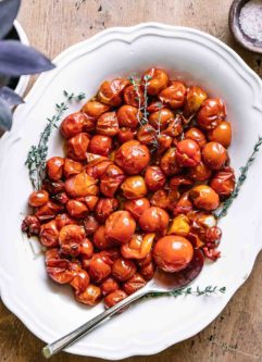 roasted cherry tomatoes on a white side dish