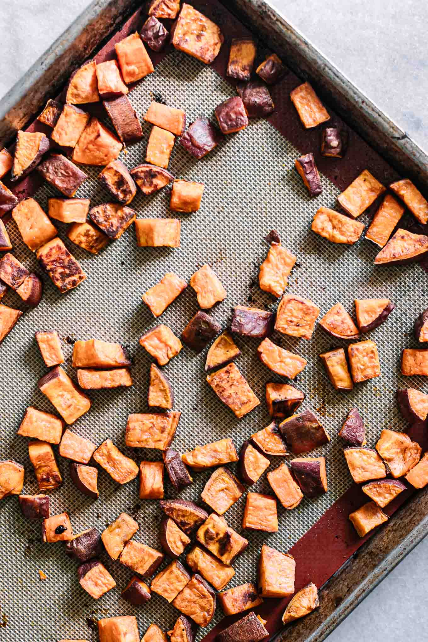baked sweet potatoes on a sheet pan after roasting