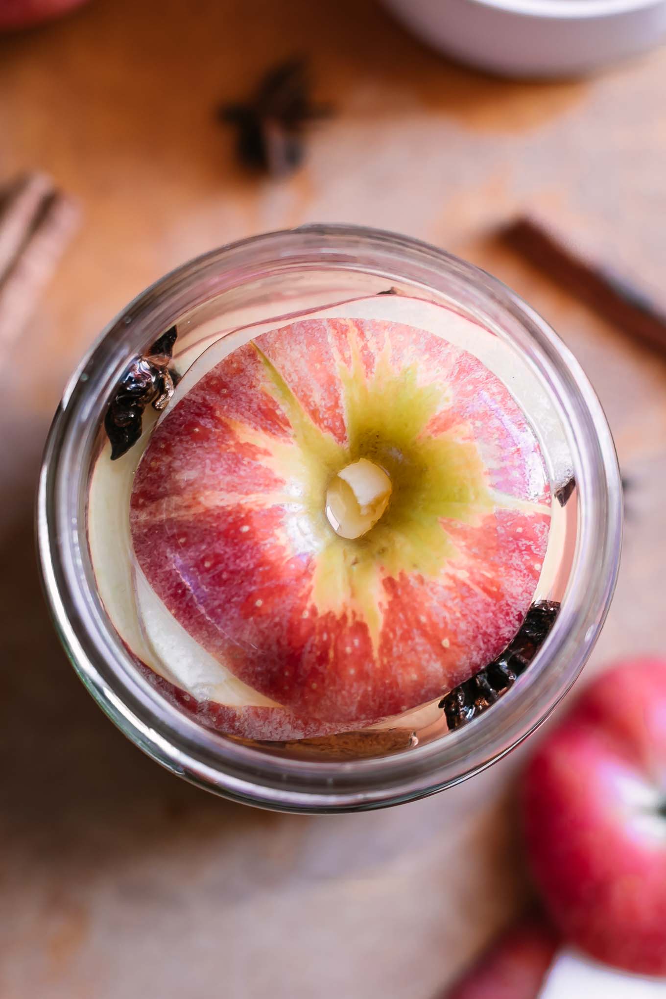 slices of apples into jar with pickling brine