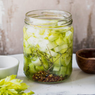 refrigerator pickled celery in a jar on a white table