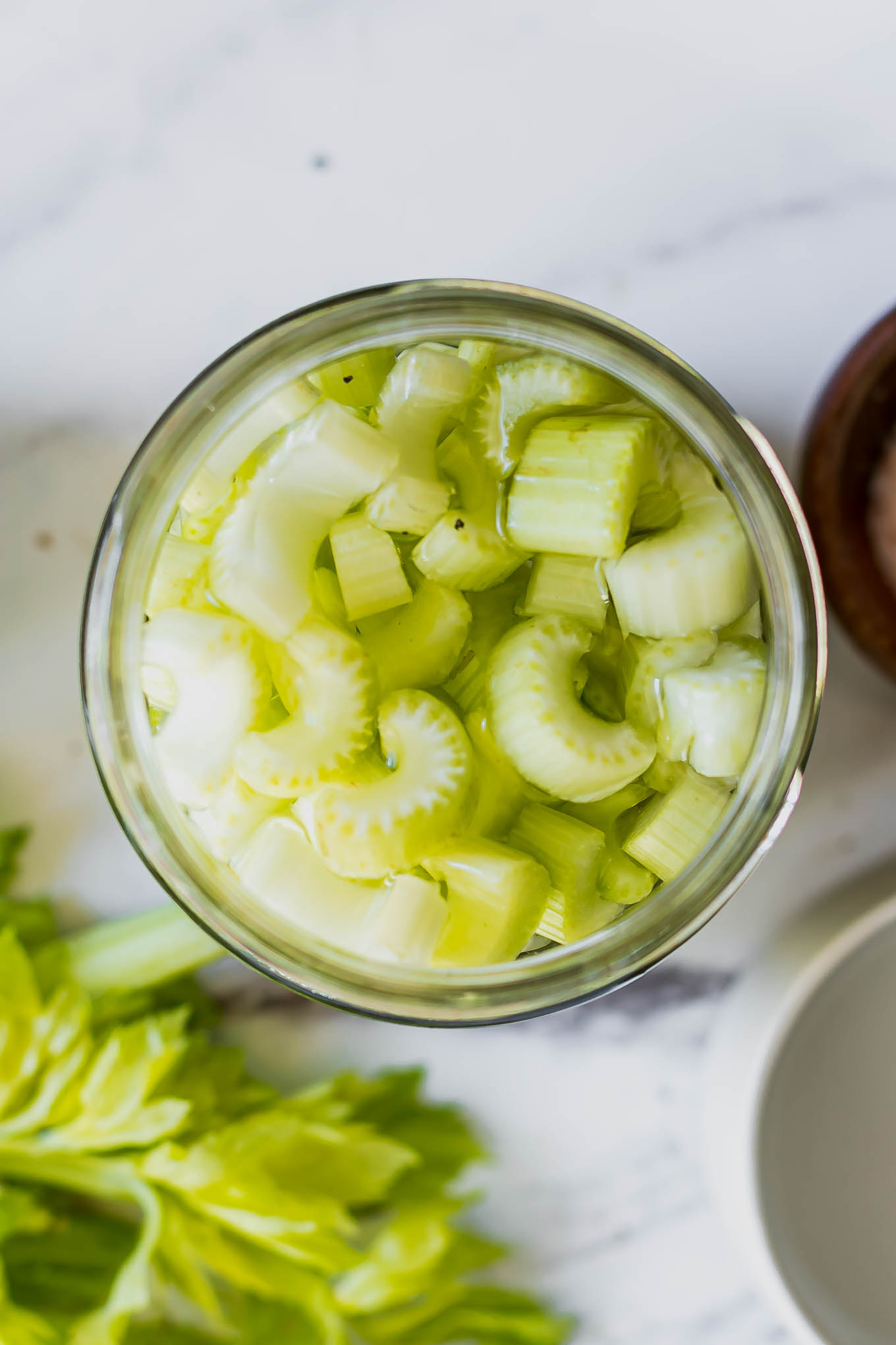 a close up photo of pickled celery in a jar