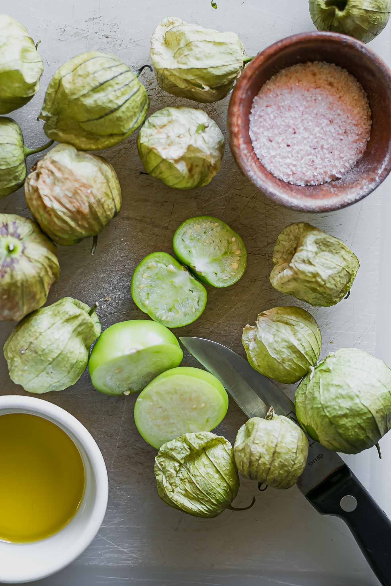 cut tomatillos on a cutting board