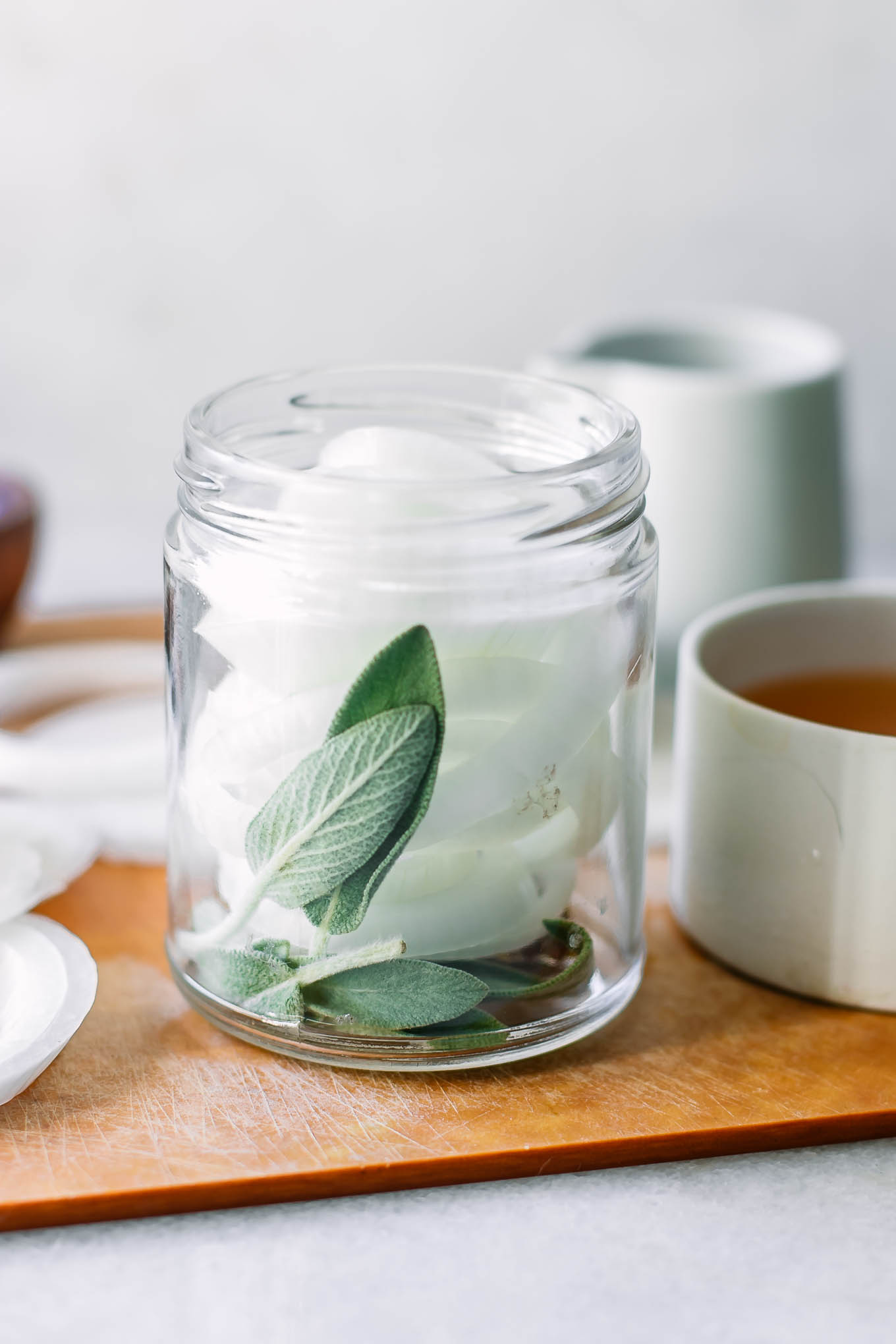 cut onions in a jar with herbs before pickling