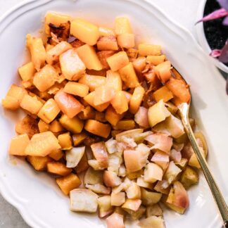 roasted apples and butternut squash on a white side dish