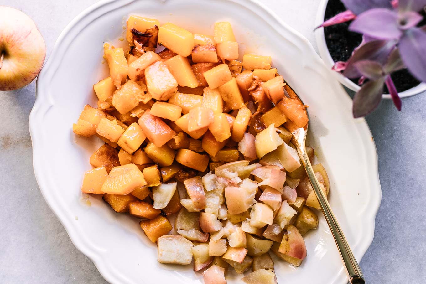 roasted apples and butternut squash on a white side dish