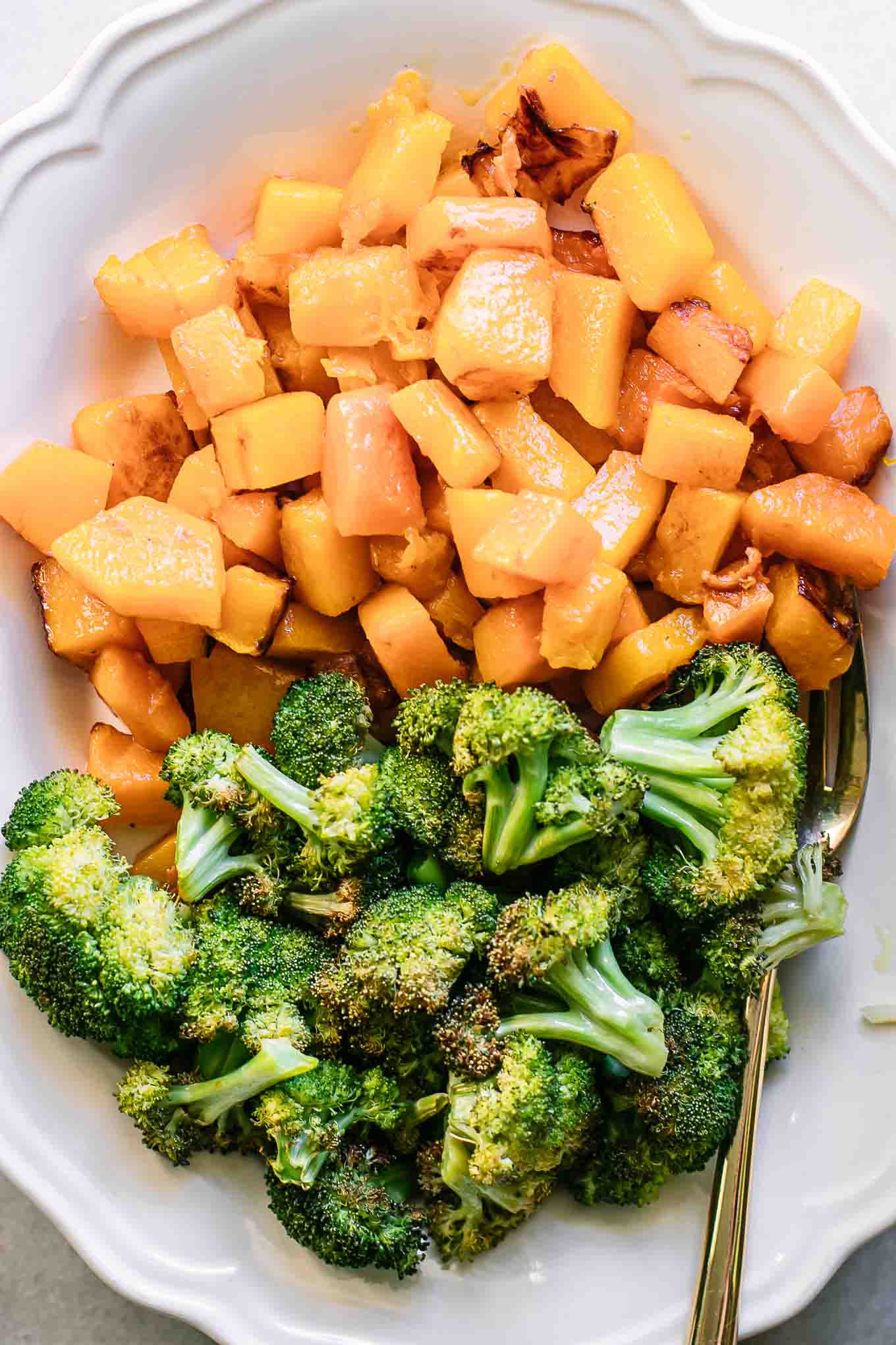 a close up photo of baked butternut squash and broccoli side dish