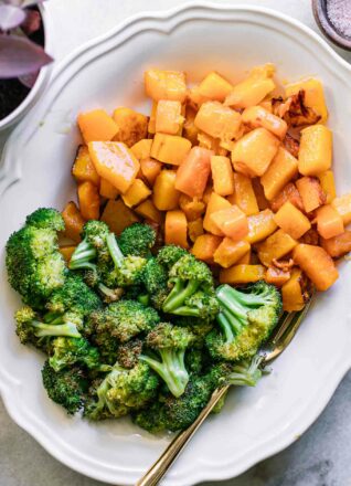 roasted butternut squash and broccoli on a white side dish