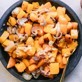 a blue side dish with baked butternut squash and shallots