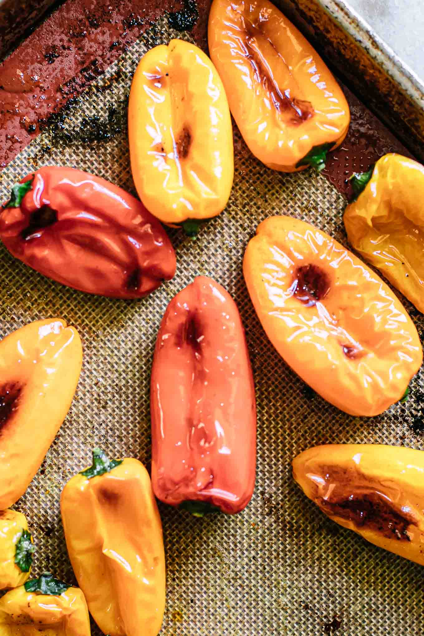 roasted sweet peppers on a baking sheet after coming out of the oven