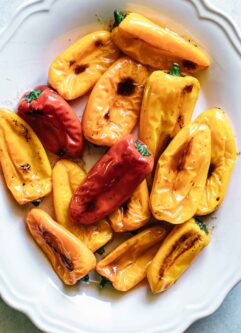 colorful roasted mini peppers on a white serving plate