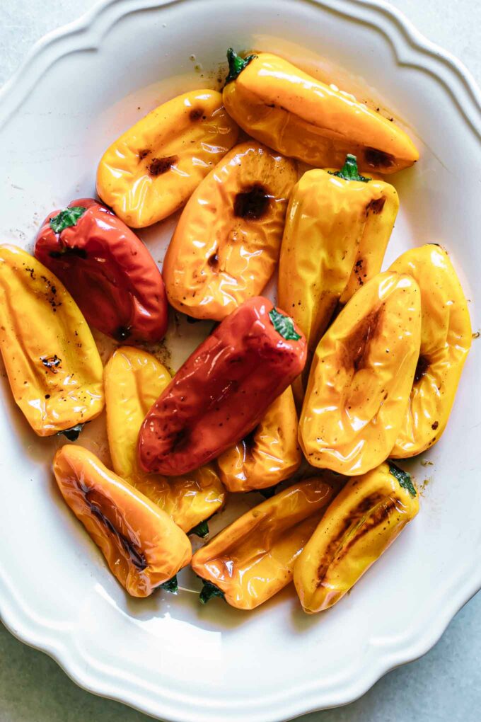 colorful roasted mini peppers on a white serving plate