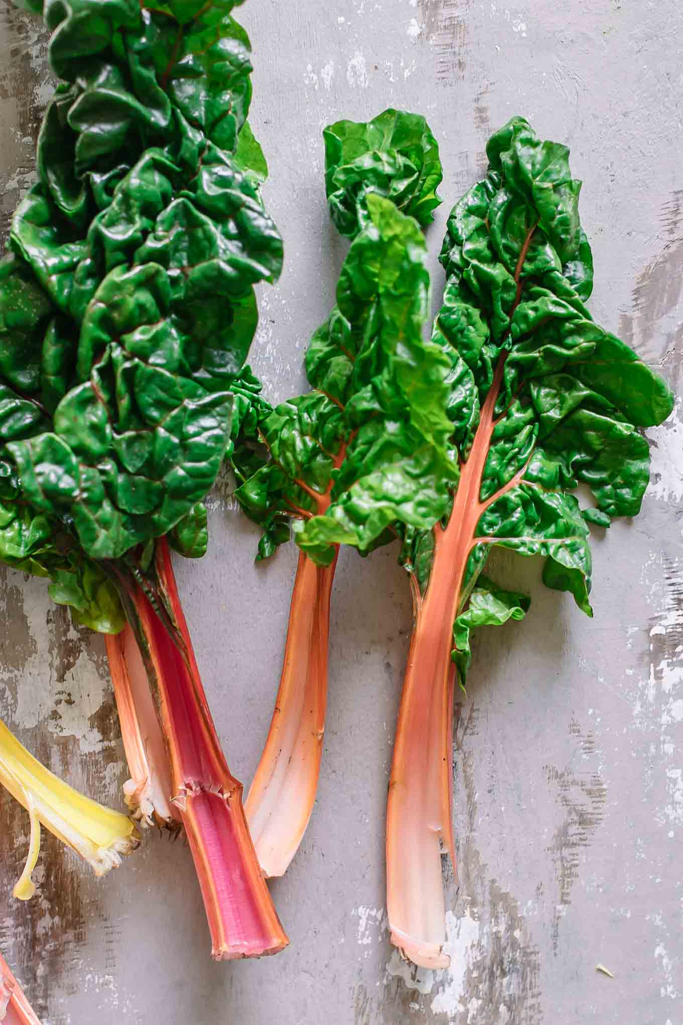 rainbow chard leaves on a wood table