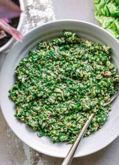 chard leaves pesto sauce in a bowl with a gold fork