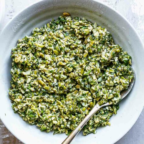pesto sauce with mint leaves in a bowl on a white table