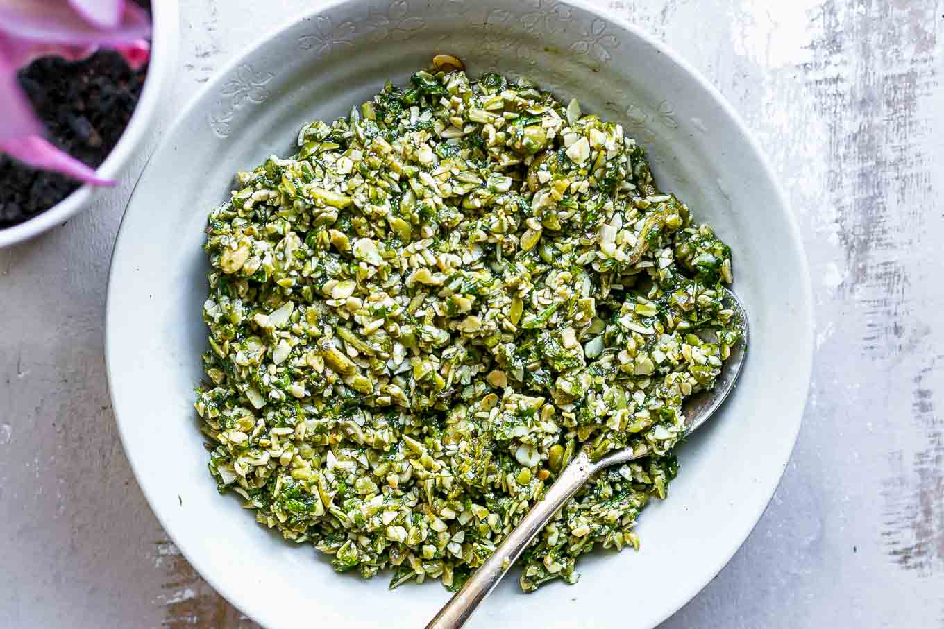 pesto sauce with mint leaves in a bowl on a white table