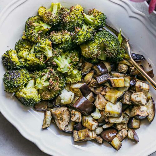 a baked broccoli and eggplant side dish on a white table