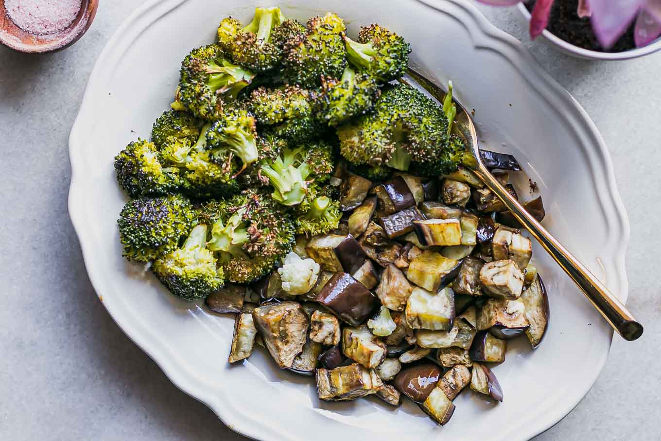 a baked broccoli and eggplant side dish on a white table