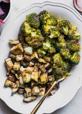 roasted broccoli and eggplant side dish on a white table