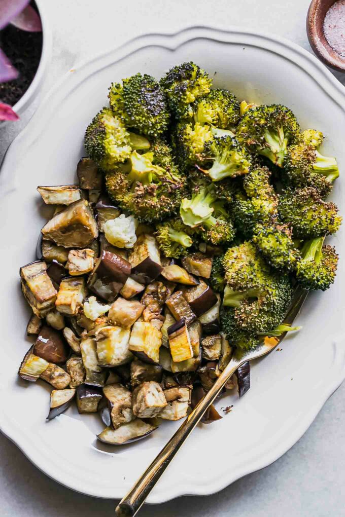 roasted broccoli and eggplant side dish on a white table