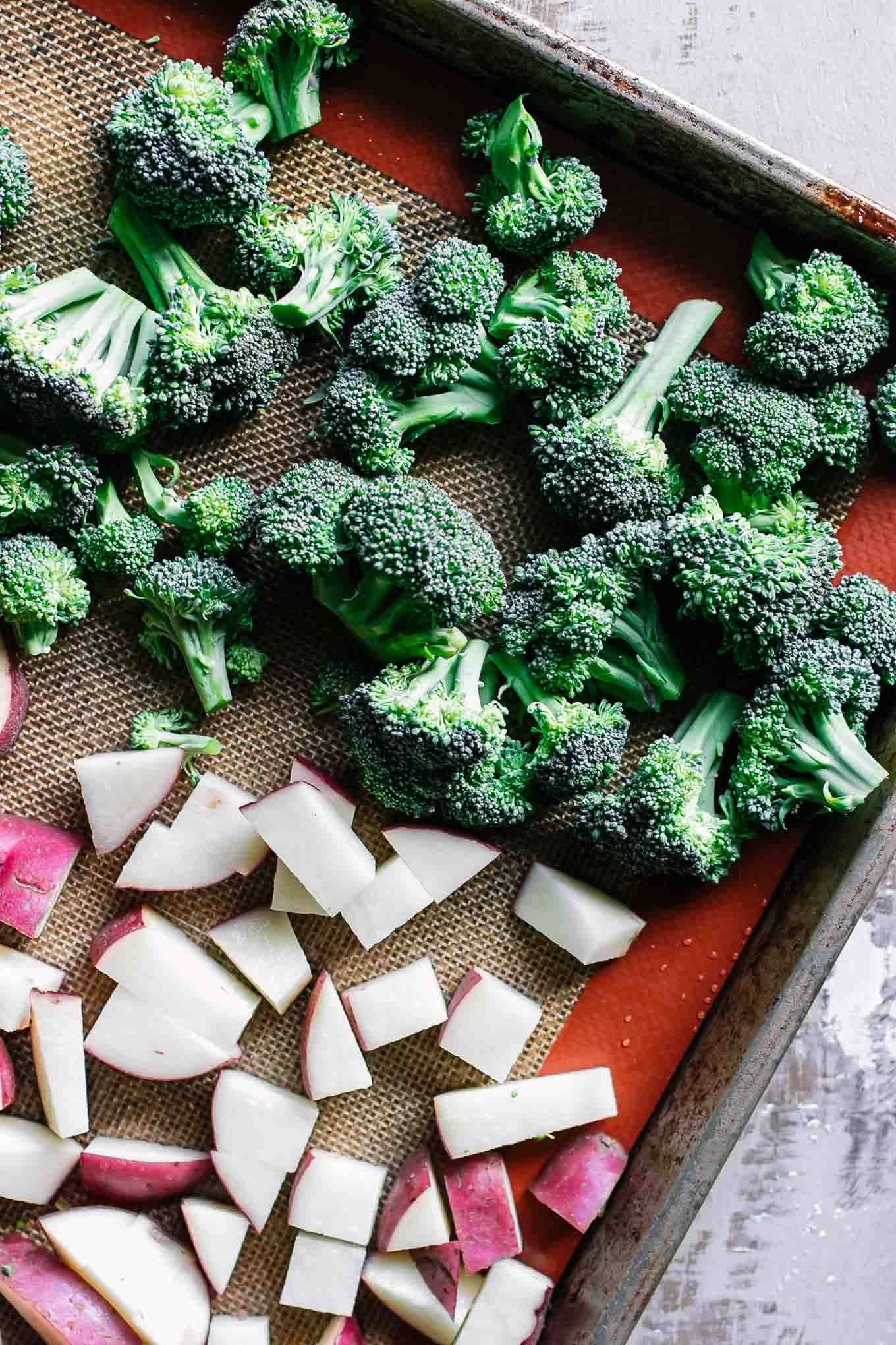 broccoli florets and cut potatoes on a baking sheet before roasting