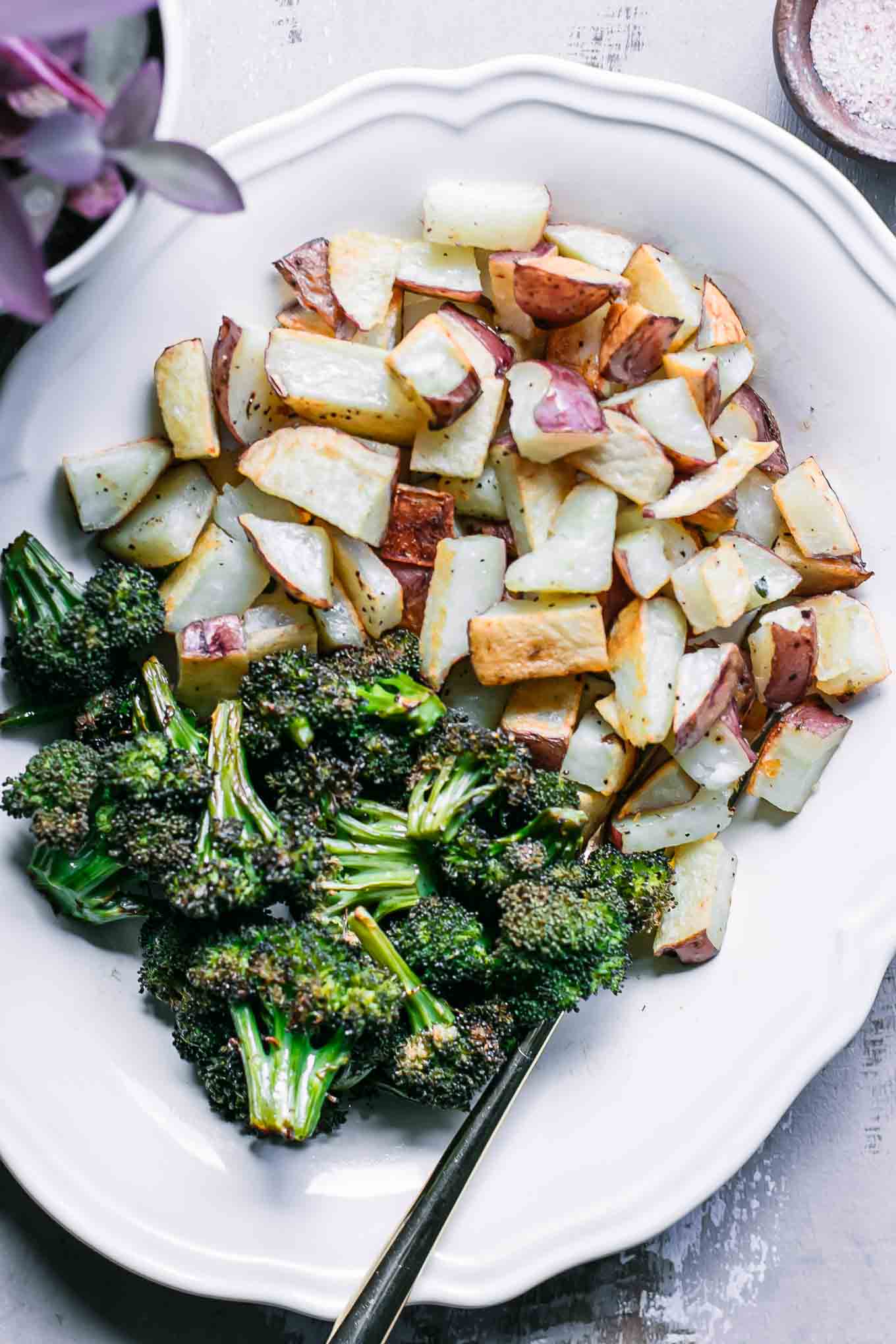 roasted potatoes and broccoli on a white plate