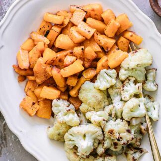 baked cauliflower and butternut squash side dish on a wood table