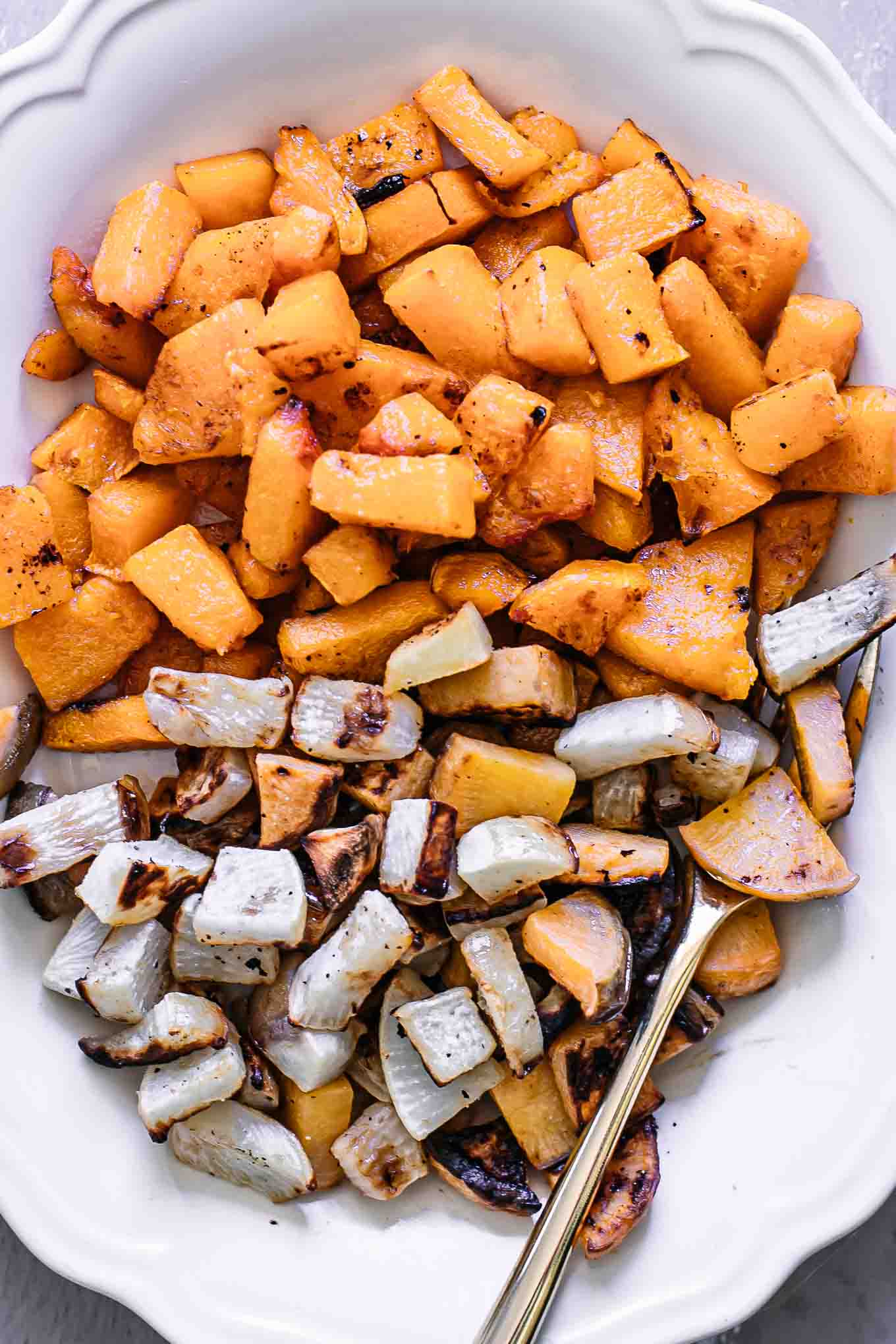 a close up of a baked turnips and butternut squash side dish