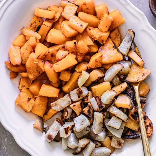 roasted turnips and butternut squash on a white side dish plate