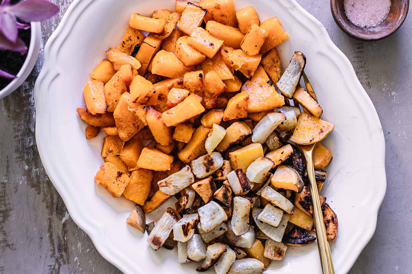 roasted turnips and butternut squash on a white side dish plate