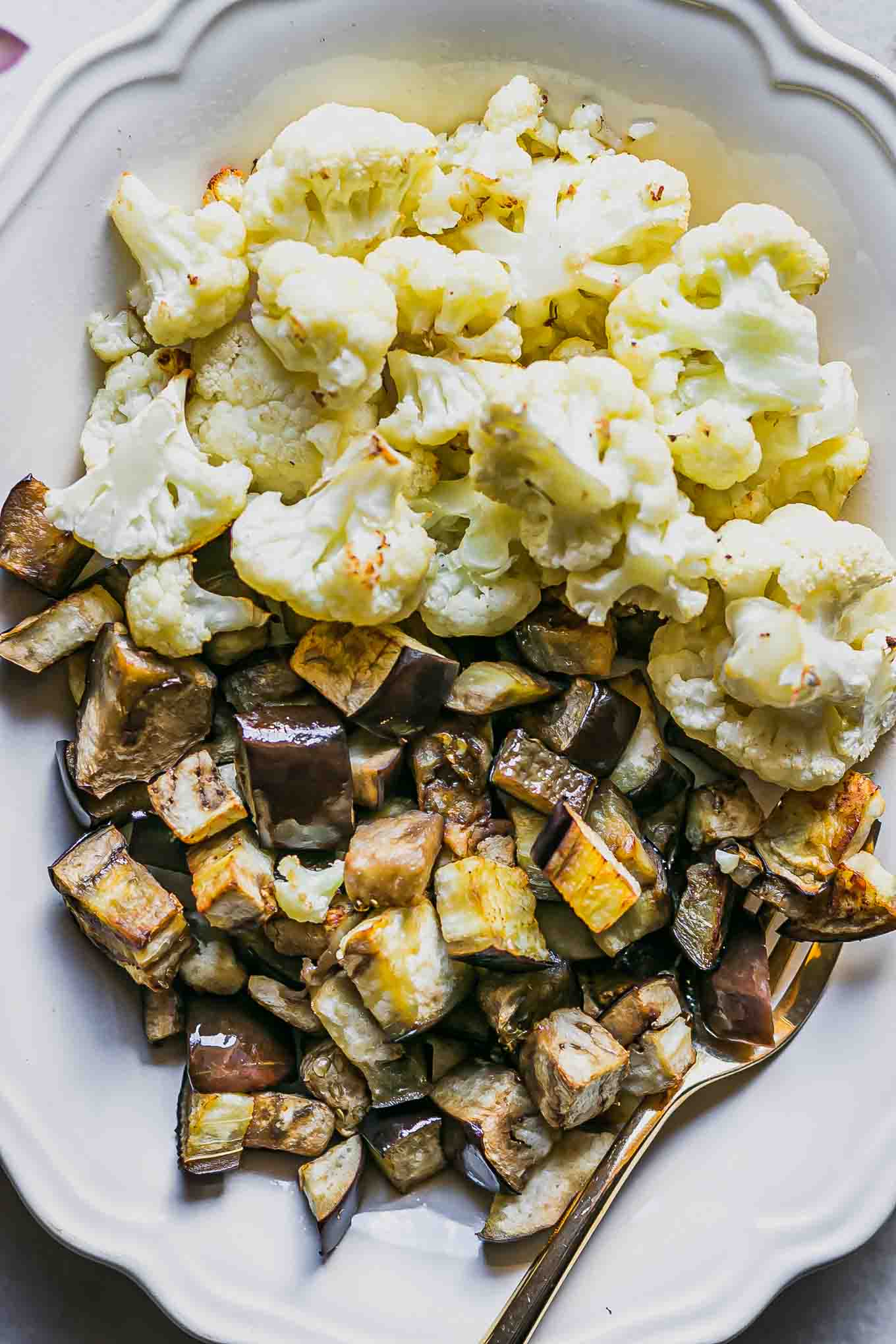 a close up photo of roasted eggplant and cauliflower