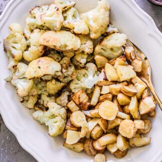 roasted parsnips and cauliflower on a white side dish plate