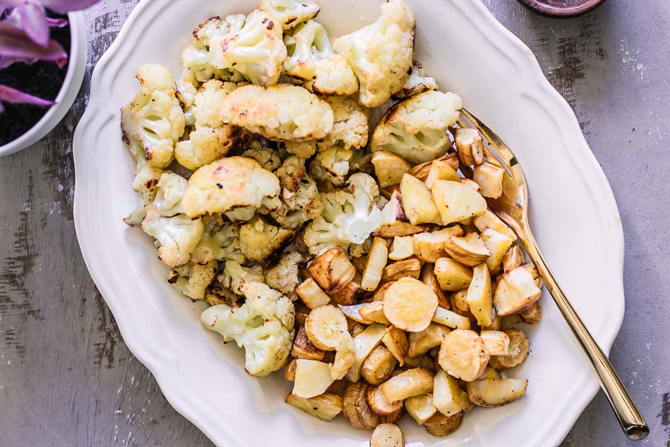roasted parsnips and cauliflower on a white side dish plate