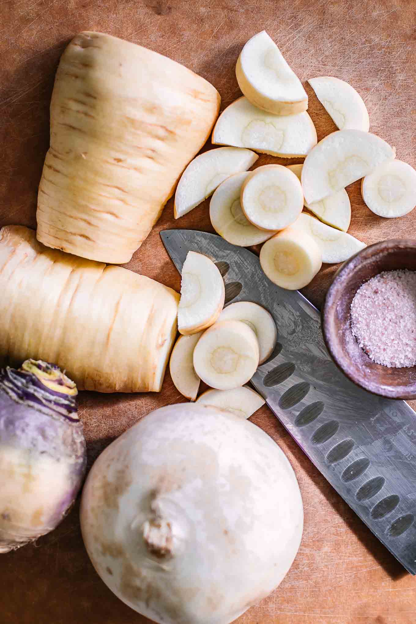 cut parsnips and turnips on a wood cutting board