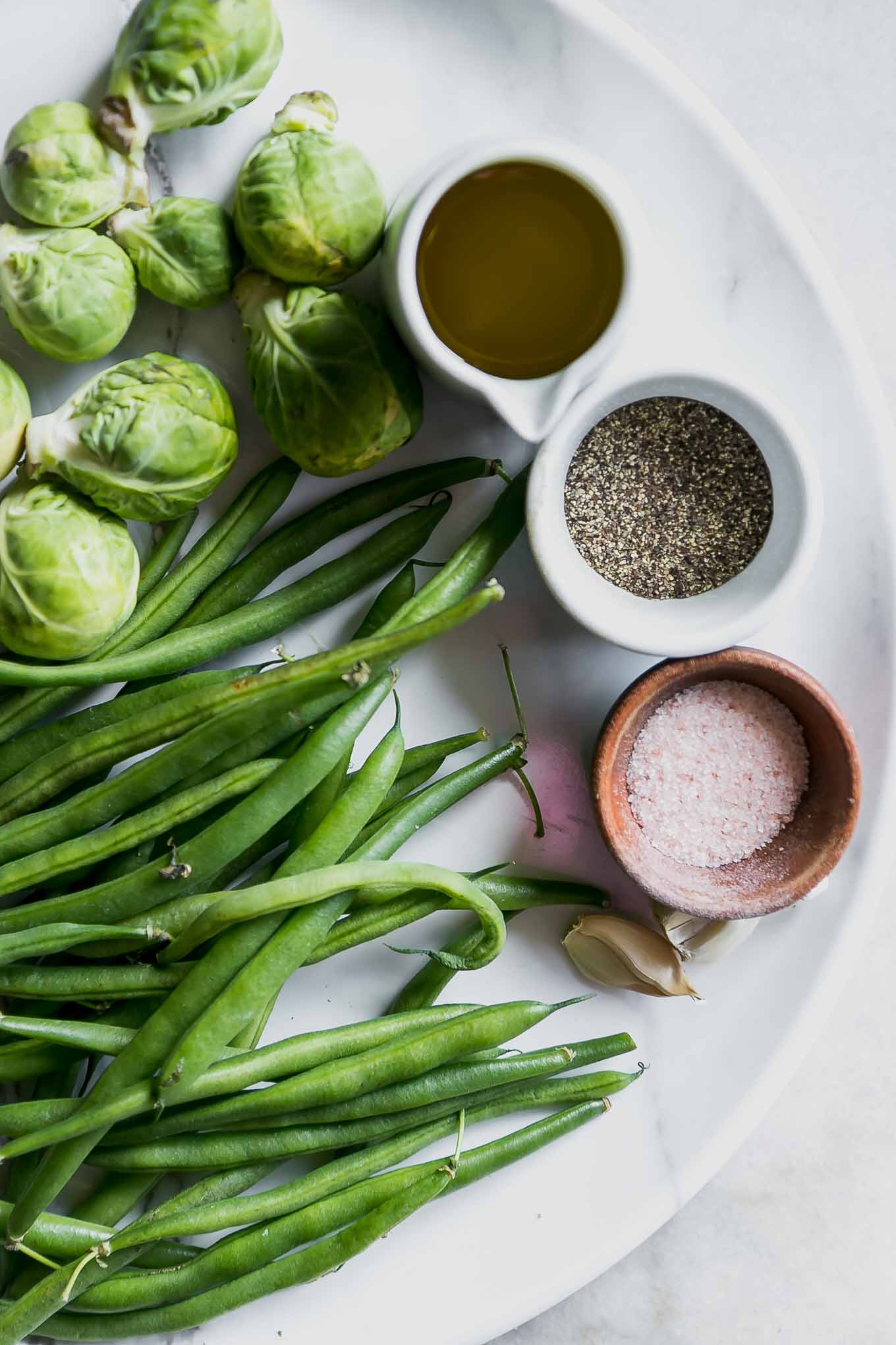 green beans, brussels sprouts, garlic, oil, salt, pepper