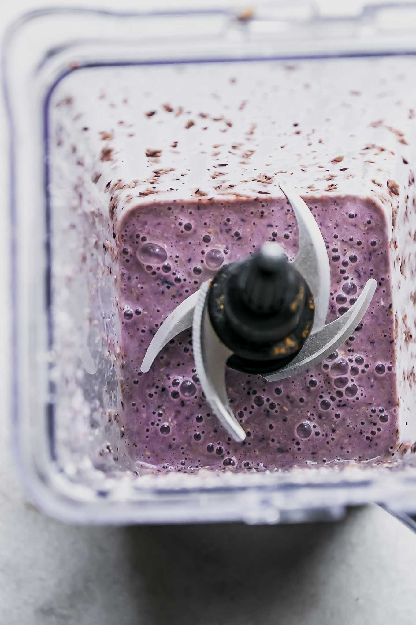a blueberry smoothie in a blender after mixing