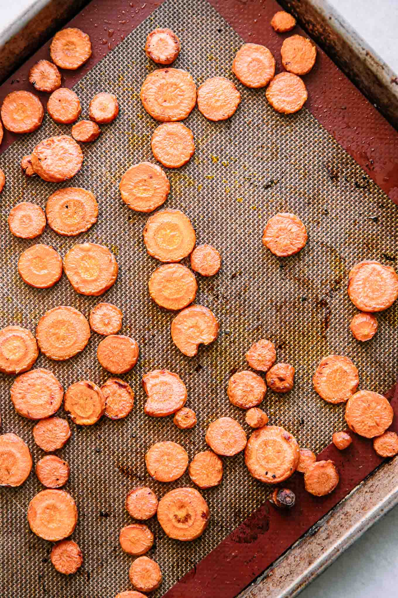 roasted sliced carrots on a baking sheet after baking