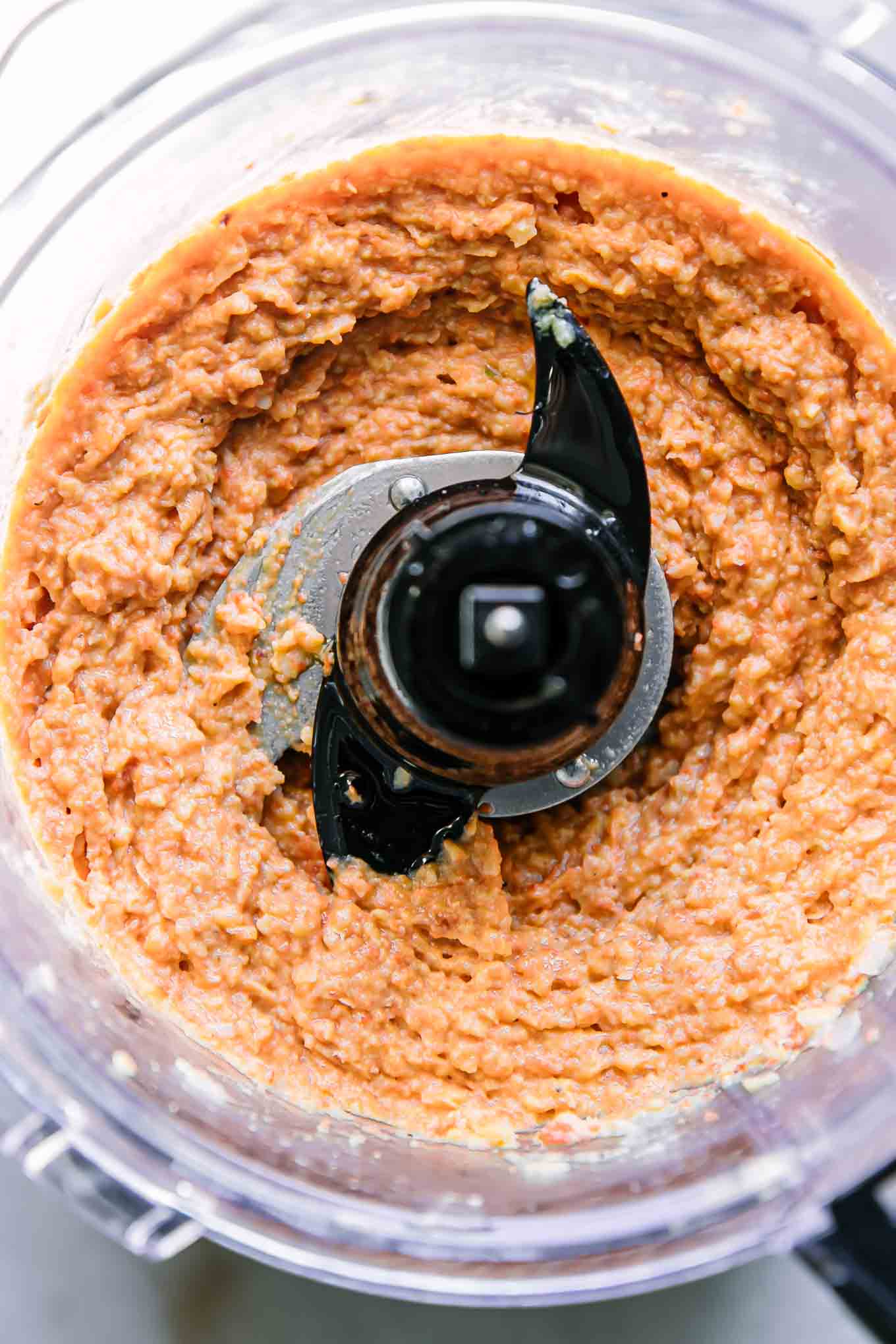 blended hummus with carrots in a food processor