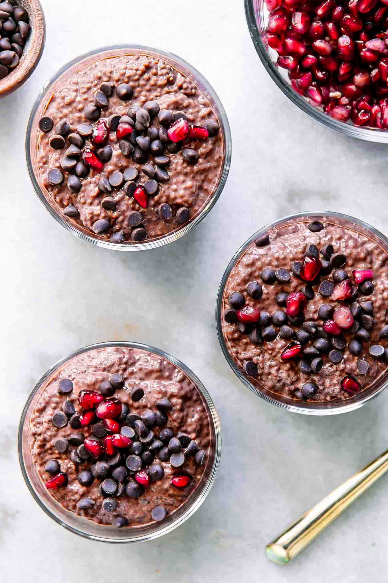 chocolate chia seed pudding cups on a white table