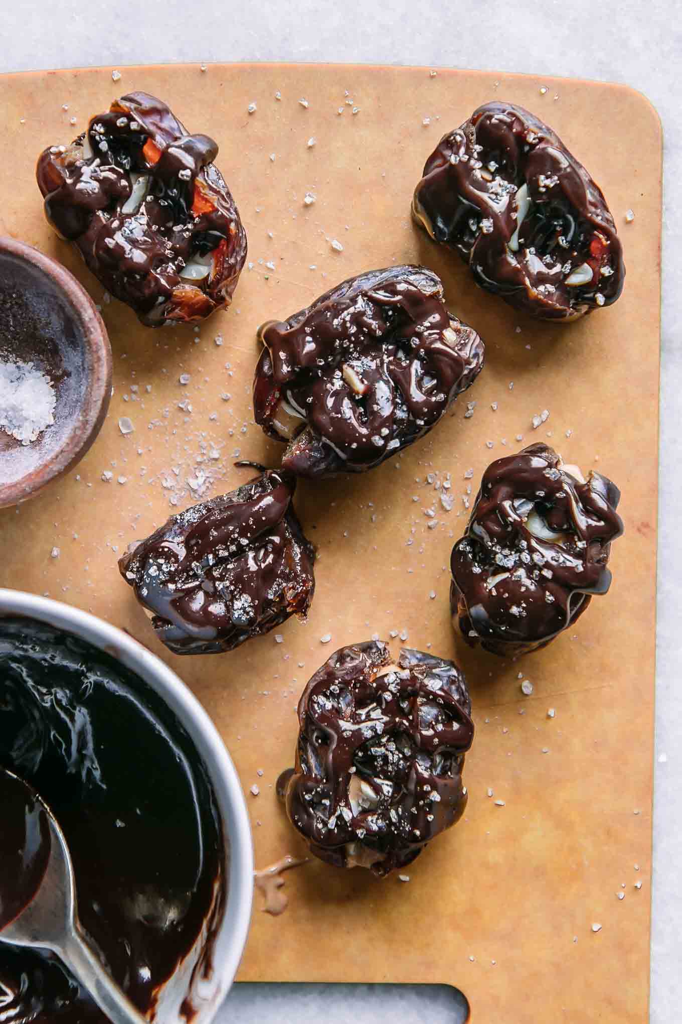 chocolate covered stuffed dates on a cutting board