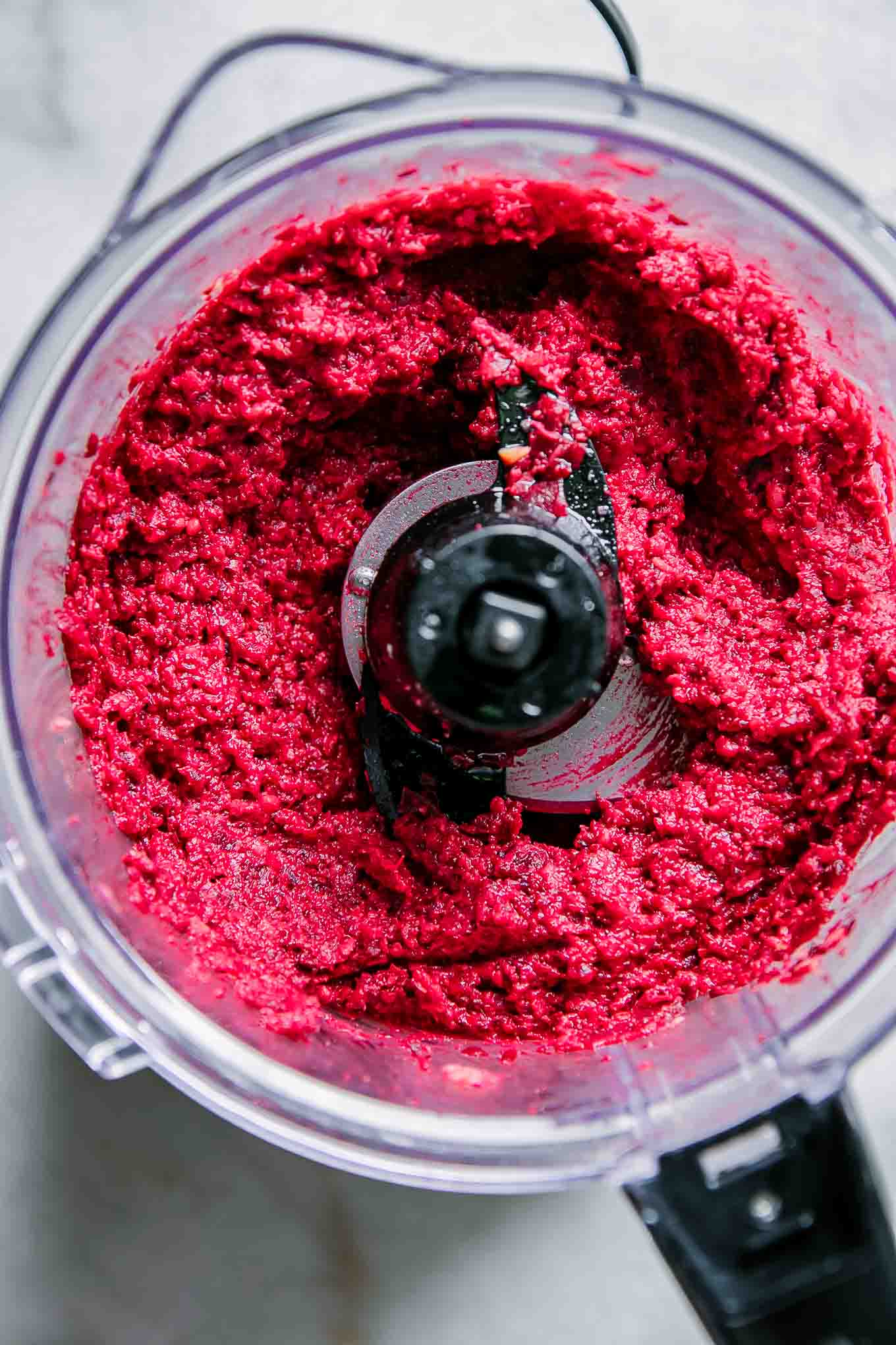 red beet hummus in a food processor after blending