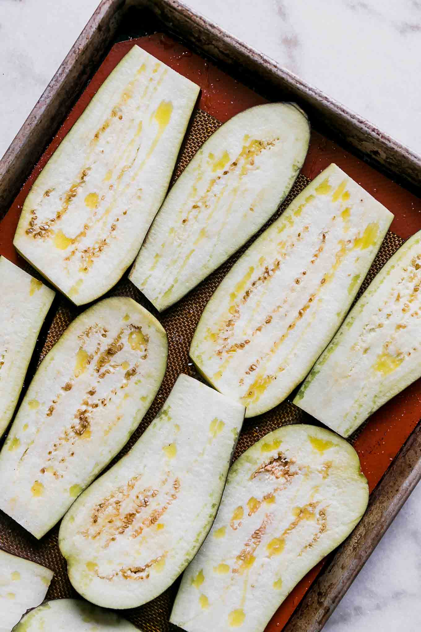 eggplant slices on a baking sheet before roasting