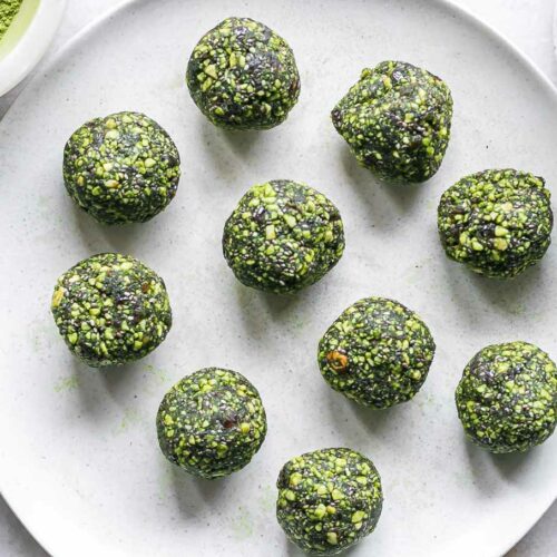 green energy balls with green tea matcha powder on a white plate