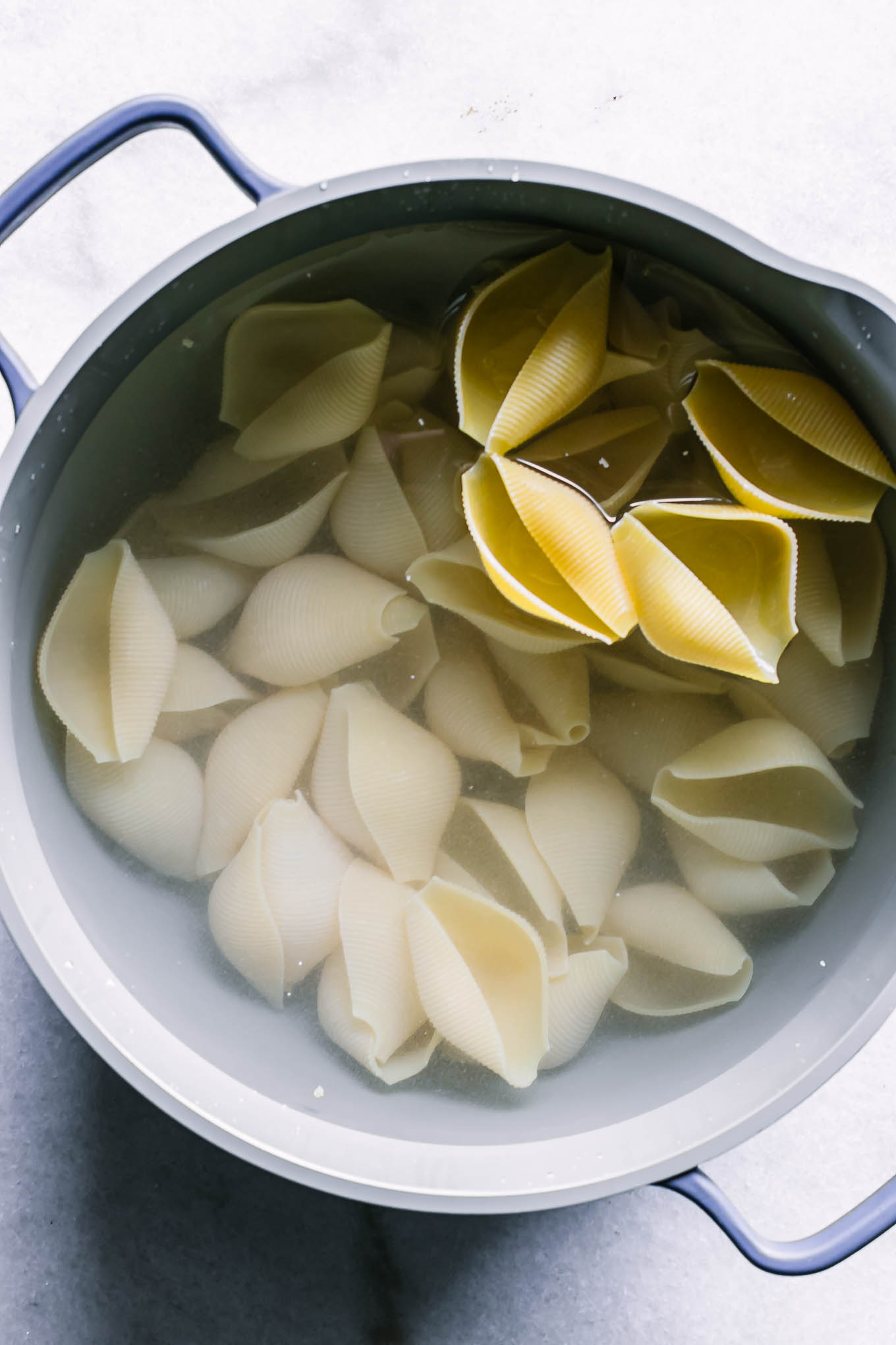 a pot with water and jumbo pasta shells