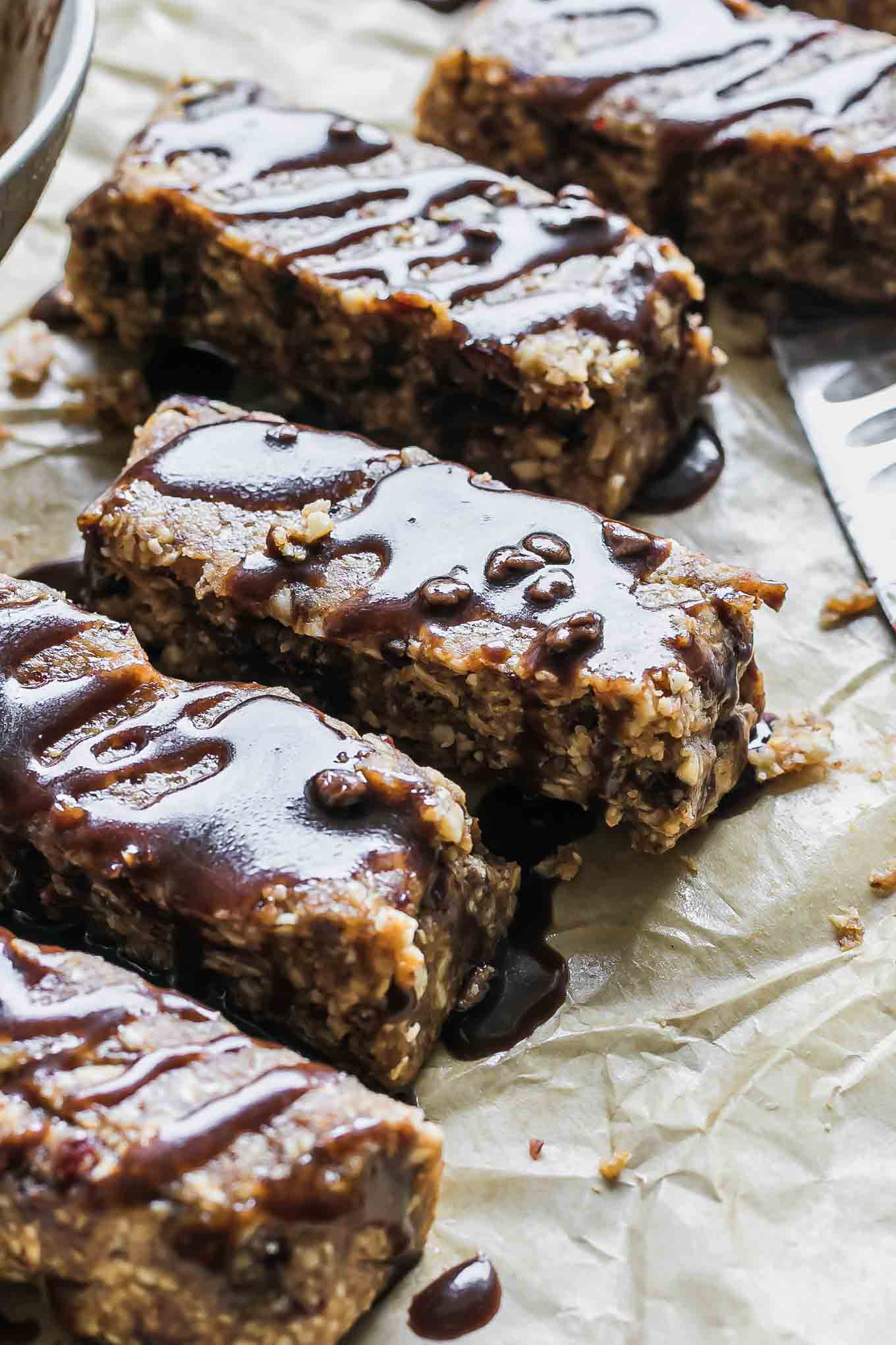 chocolate peanut butter granola bars with drizzled chocolate on top