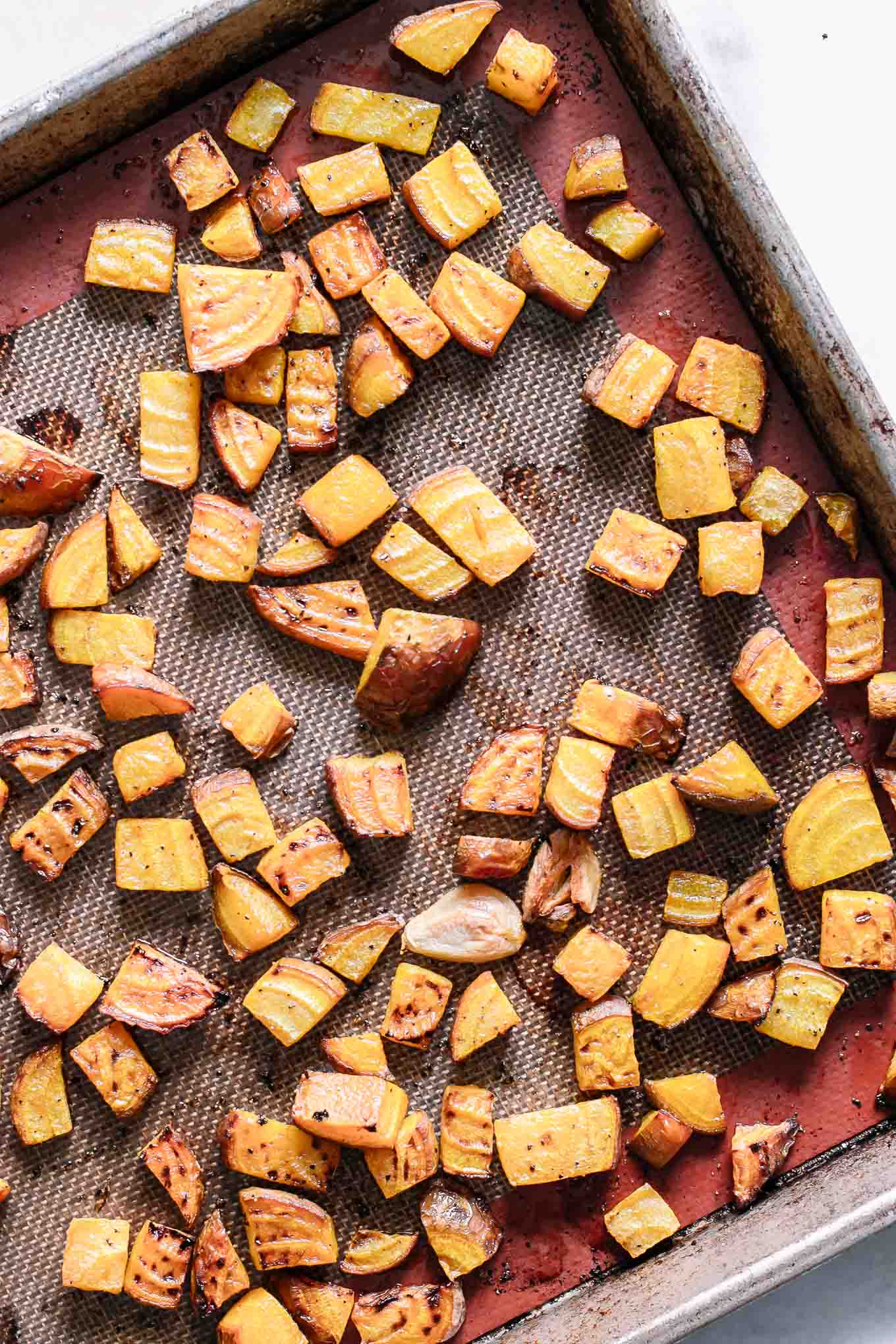 a roasting pan with cooked golden beets after baking