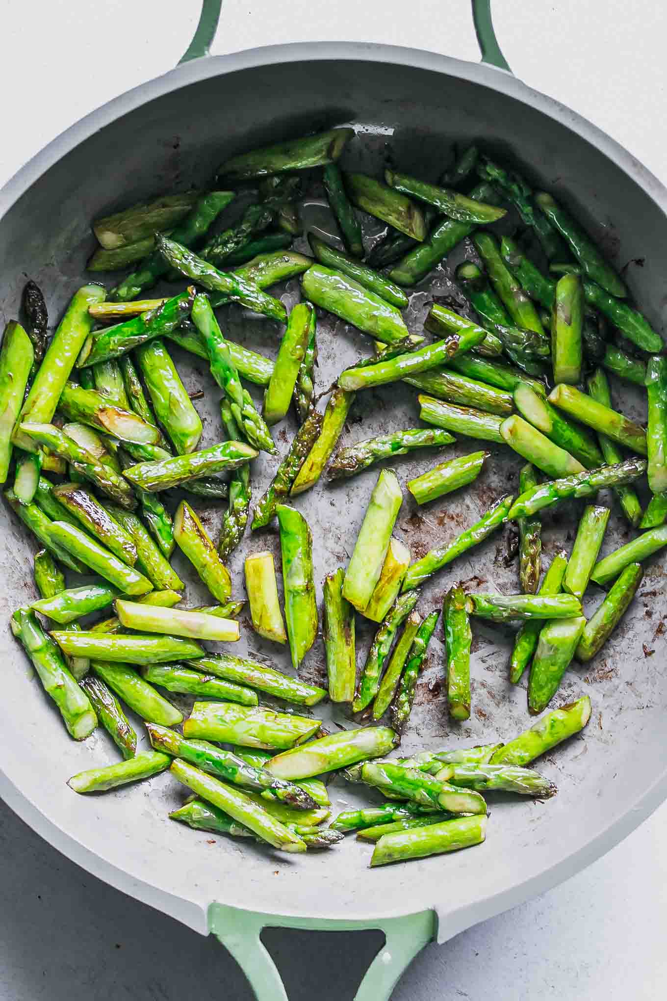 cooked asparagus pieces inside a pan