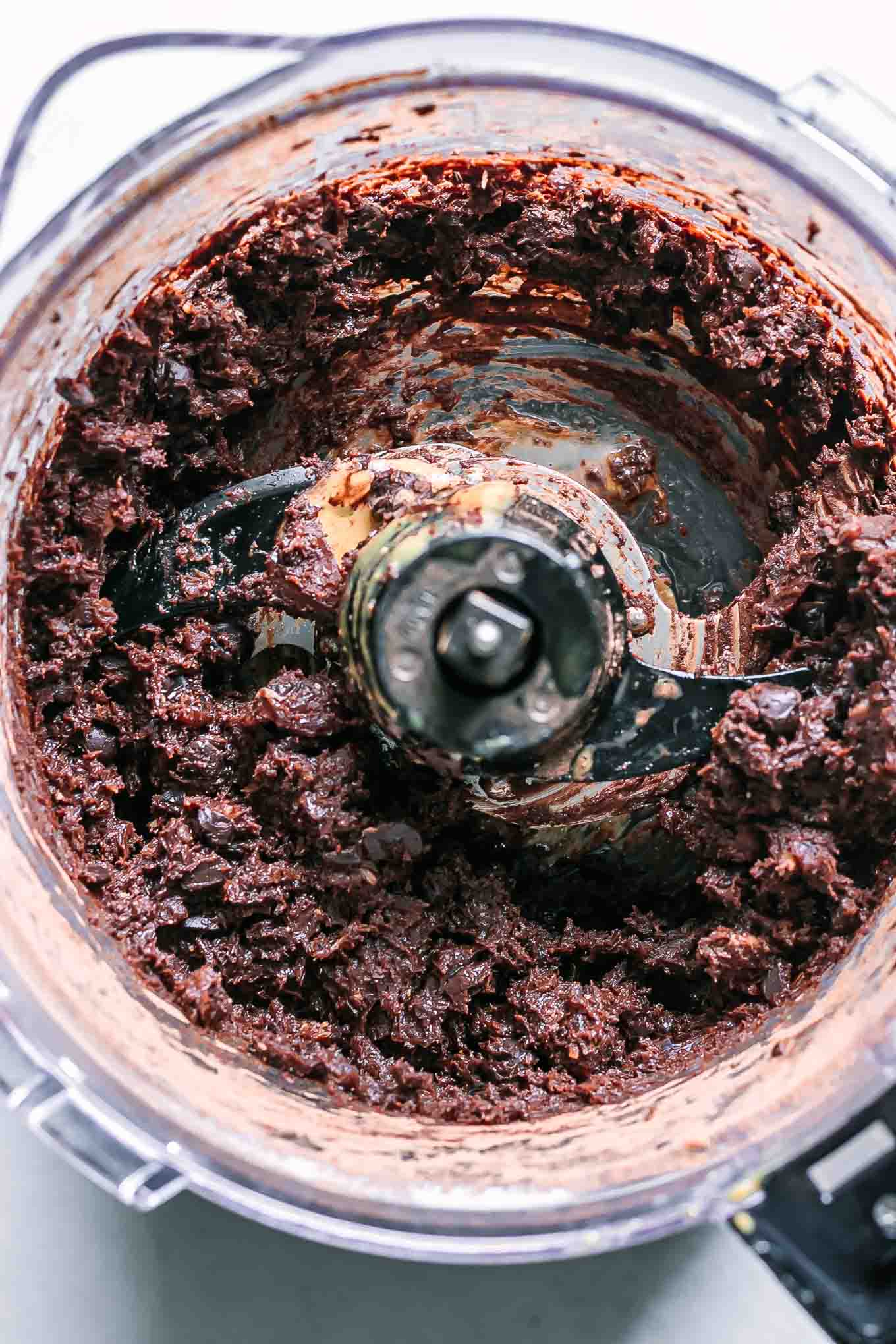 blended brownie bite ingredients inside a food processor